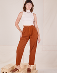 Alex is 5'8" and wearing XXS Heavyweight Trousers in Burnt Terracotta paired with Sleeveless Turtleneck in vintage tee off-white