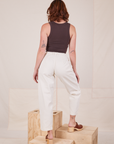 Back view of Heavyweight Trousers in Vintage Tee Off-White and espresso brown Tank Top worn by Alex.
