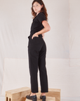 Heritage Short Sleeve Jumpsuit in Basic Black angled back view on Alex