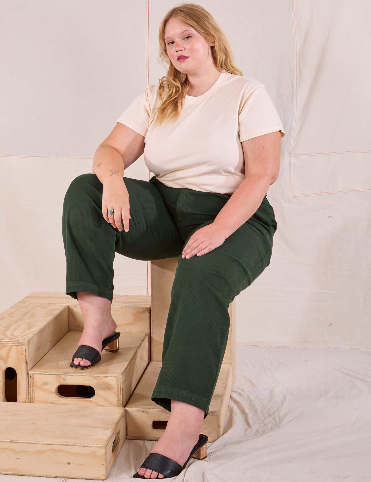 Juliet is wearing Heritage Trousers in Swamp Green and Organic Vintage Tee in vintage tee off-white