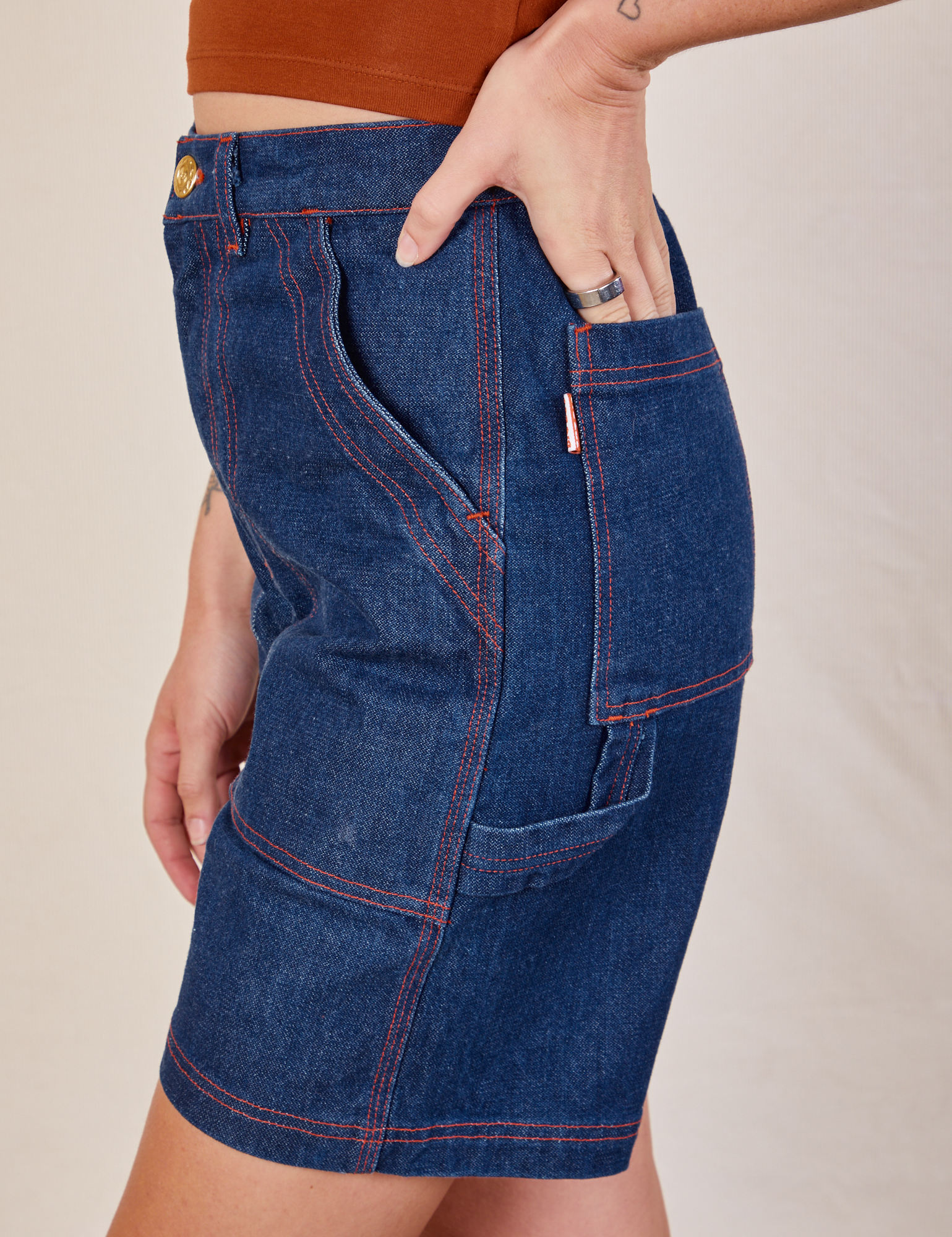 Side view of Carpenter Shorts in Dark Wash on Alex