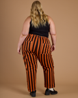 Back view of Black Stripe Work Pants in Construction Orange on Juliet