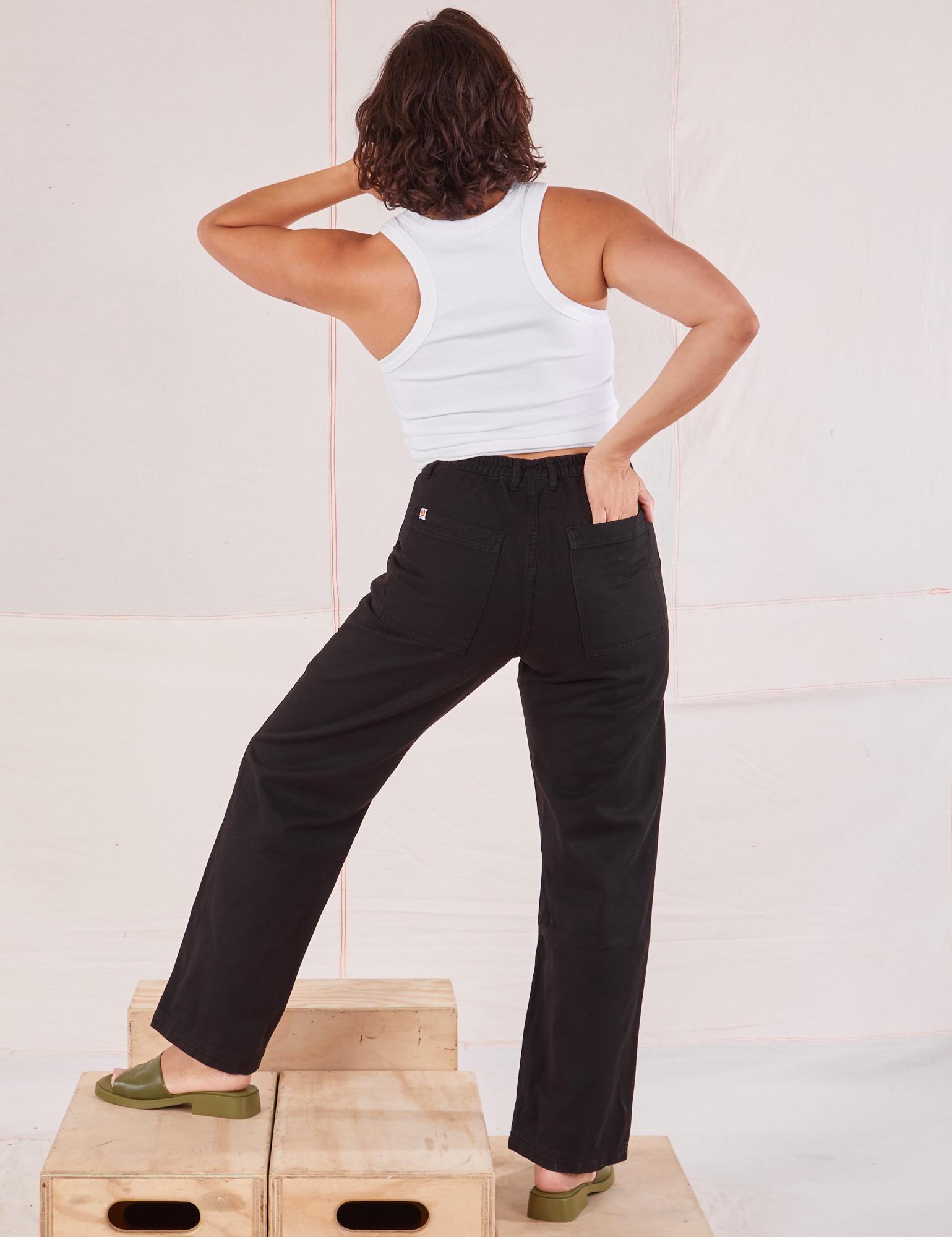 Back view of Organic Work Pants in Basic Black and Racerback Tank in vintage tee off-white on Tiara