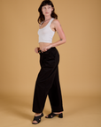 Alex is wearing Baggy Mid-Rise Trousers in Basic Black and vintage tee white Cropped Tank