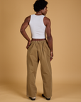 Back view of Baggy Mid-Rise Trousers in Desert Brown and vintage tee white Cropped Tank on Jerrod