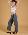 Angled front view of Baggy Mid-Rise Trousers in Slate Grey and vintage tee white Cropped Tank on Alex