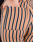 Work Pants in Autumn Stripe back pocket close up with Alex's hand tucked into the pocket.