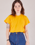 Hana is wearing Organic Vintage Tee in Sunshine Yellow tucked into dark wash Carpenter Jeans