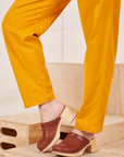Pant leg close up of Organic Trousers in Mustard Yellow on Alex