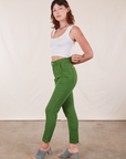 Side view of Pencil Pants in Lawn Green and Cropped Tank Top in vintage tee off-white