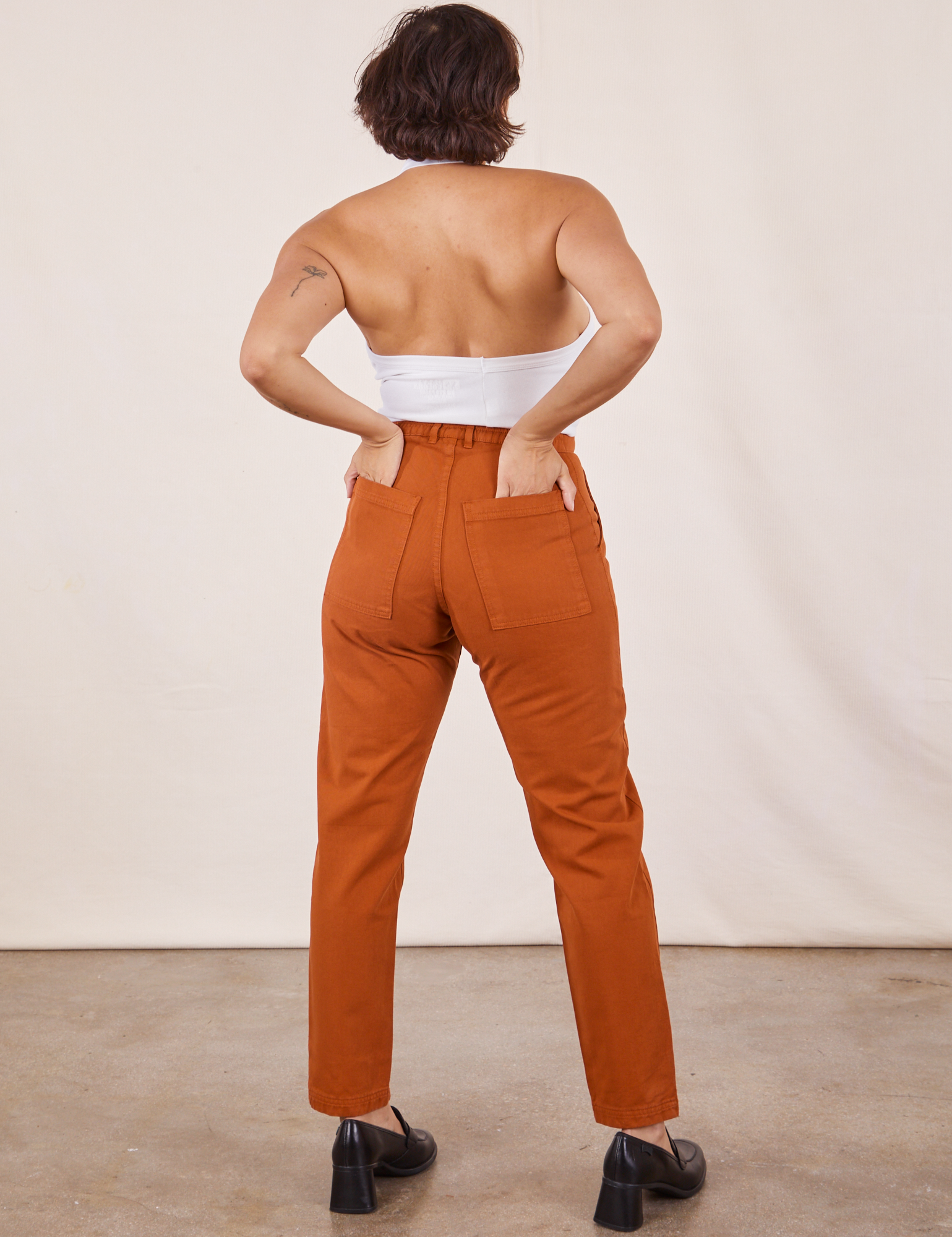 Back view of Pencil Pants in Burnt Terracotta and Halter Top in vintage tee off-white worn by Tiara