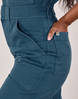 Petite Short Sleeve Jumpsuit in Lagoon side close up. Kandia has her hand in the back pocket.