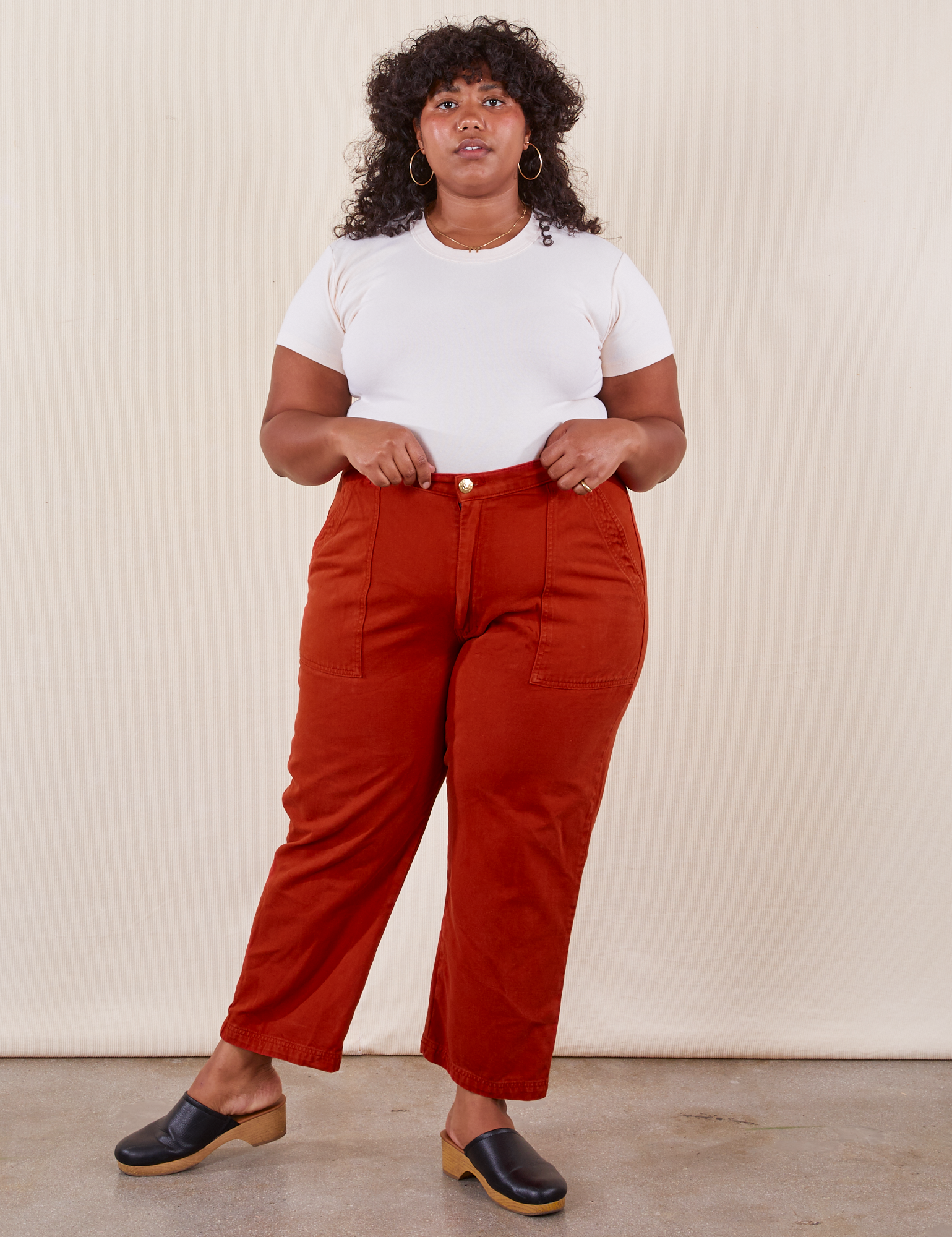 Morgan is 5&#39;5&quot; and wearing Petite 1XL Work Pants in Paprika paired with a Baby Tee in  vintage tee off-white