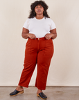 Morgan is 5'5" and wearing Petite 1XL Work Pants in Paprika paired with a Baby Tee in  vintage tee off-white