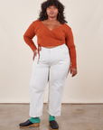 Morgan is 5'5" and wearing Petite 1XL Work Pants in Vintage Off-White paired with burnt terracotta Wrap Top