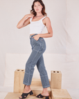 Side view of Carpenter Jeans in Indigo Railroad and vintage tee off-white Square Neck Tank