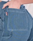 Close up of Alex's hand in the back pocket of Railroad Carpenter Shorts in Baby Blue