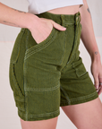 Railroad Carpenter Shorts in Summer Olive side view close up with Alex's hand in the front pocket