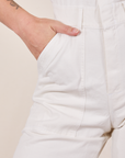 Front pocket close up of Short Sleeve Jumpsuit in Vintage Tee Off-White. Alex has her hand in the pocket.