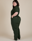 Angled back view of Short Sleeve Jumpsuit in Swamp Green on Ashley