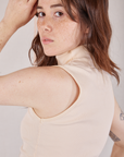 Side close up of Sleeveless Essential Turtleneck in Vintage Tee Off-White on Hana
