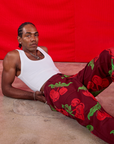 Jerrod is wearing Paintstamped Work Pants in Cherry and Cropped Tank in vintage tee off-white