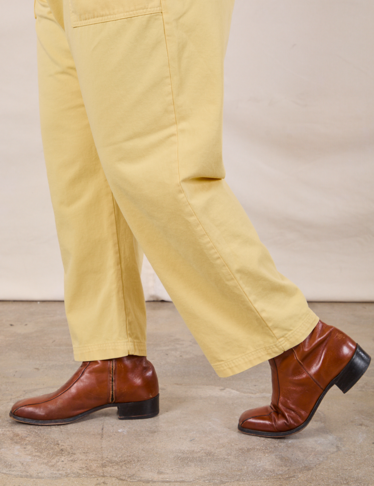 Work Pants in Butter Yellow side pant leg close up on Miguel