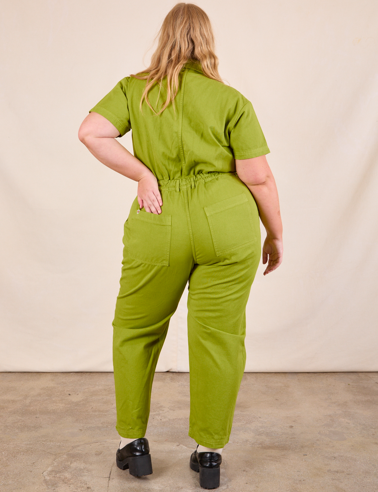 Short Sleeve Jumpsuit in Gross Green back view on Juliet
