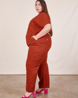 Side view of Short Sleeve Jumpsuit in Paprika worn by Marielena
