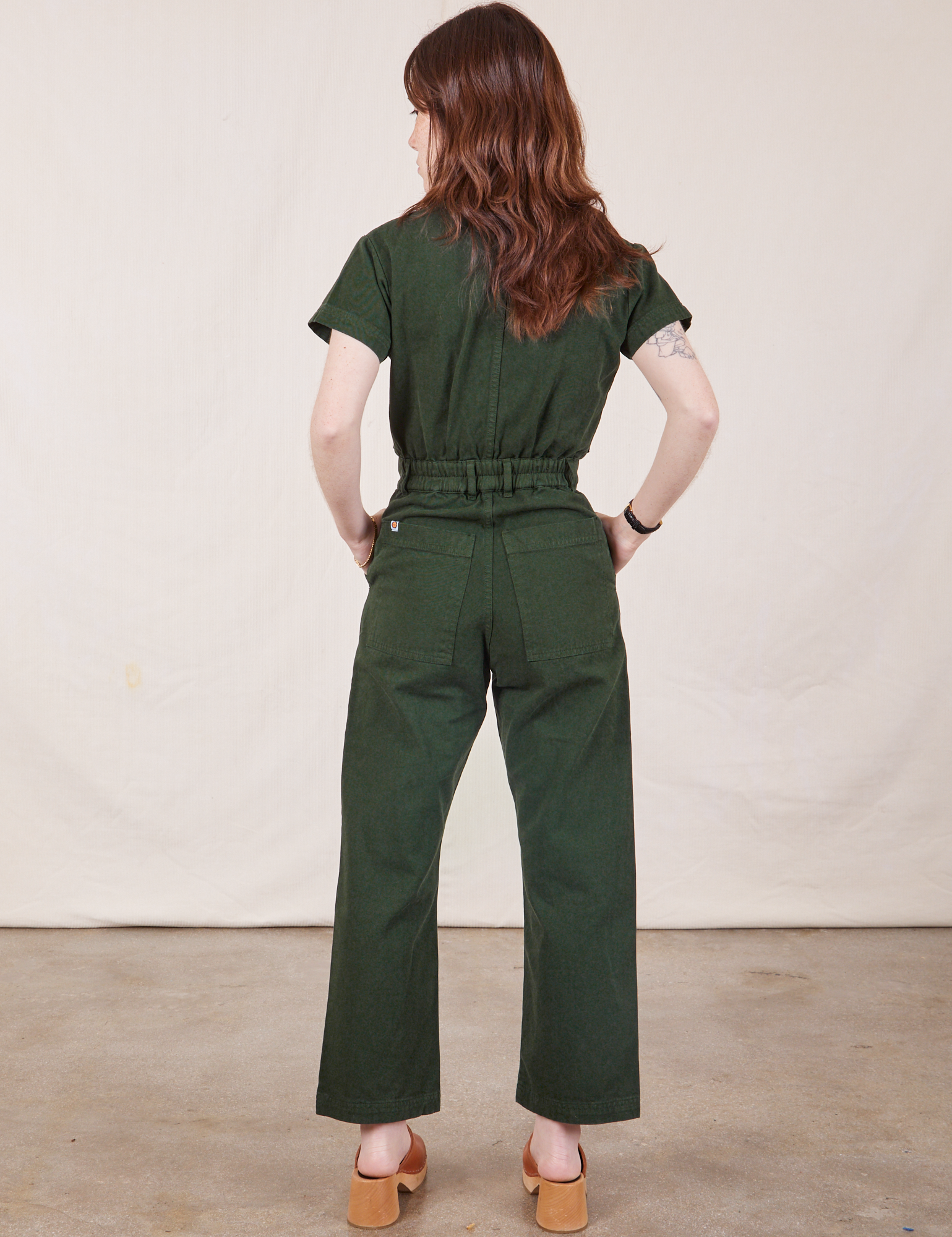 Petite Short Sleeve Jumpsuit in Swamp Green back view on Hana