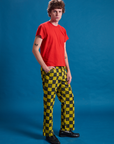 Angled front view of Checkerboard Work Pants in Yellow/Black and mustang red Organic Vintage Tee on Quinn
