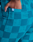 Close up of Kandia's hand in the back pocket of Checkerboard Work Pants in Blues
