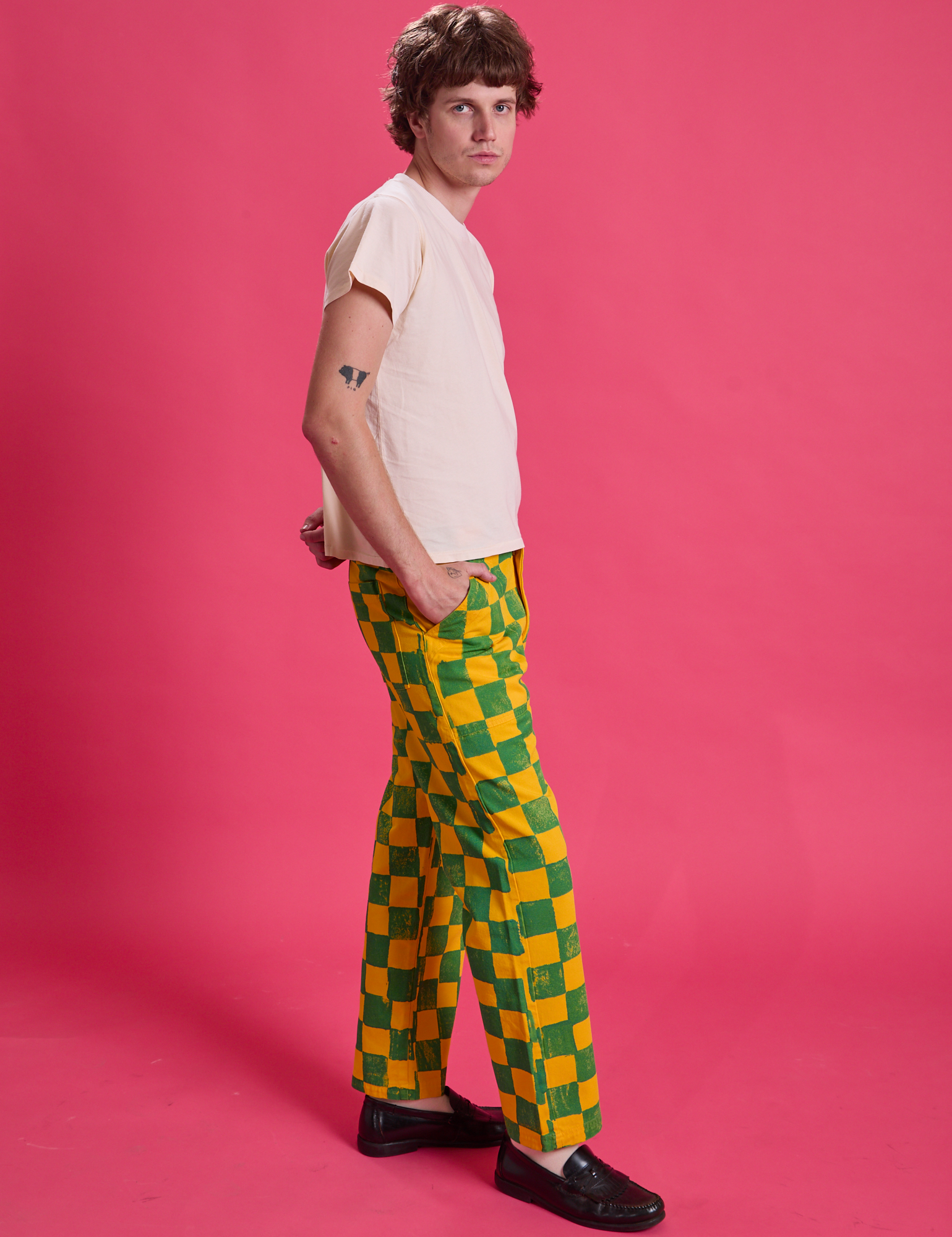 Side view of Checkerboard Work Pants in Green/Yellow and Organic Tee in Vintage Off-White