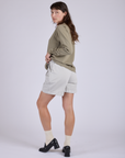 Pleated Trouser Shorts in Dishwater White angled back view on Alex