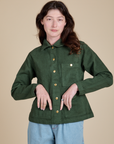 Alex is wearing a buttoned up Denim Work Jacket in Swamp Green