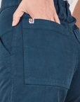 Classic Work Shorts in Lagoon back pocket close up. Madeline has her hand in the pocket.