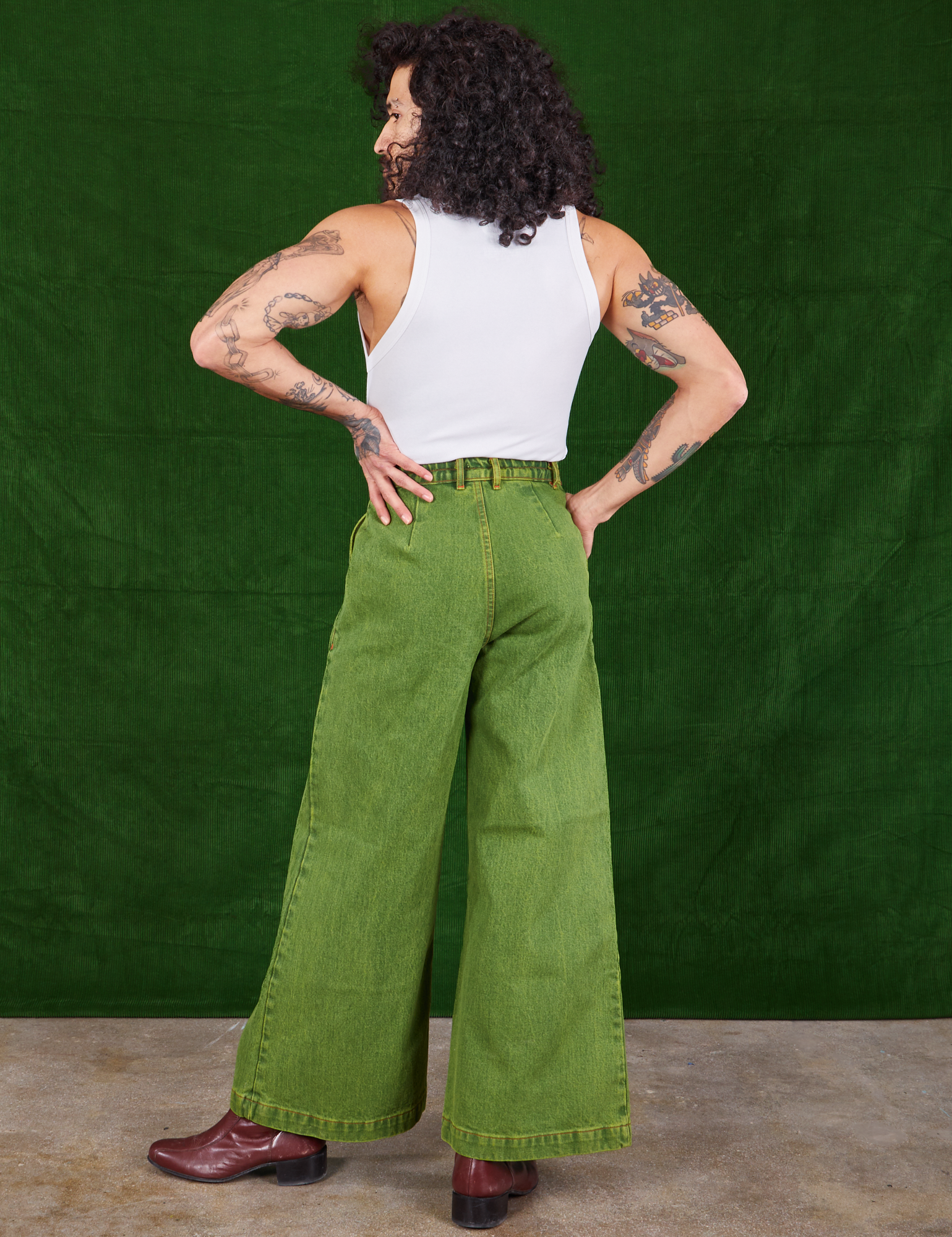 Back view of Overdyed Wide Leg Trousers in Gross Green and Cropped Tank Top in vintage tee off-white on Jesse