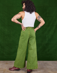 Back view of Overdyed Wide Leg Trousers in Gross Green and Cropped Tank Top in vintage tee off-white on Jesse
