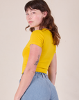 Baby Tee in Golden Yellow angled back view on Alex