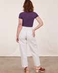 Back view of Baby Tee in Nebula Purple and vintage off-white Trousers worn by Alex