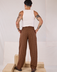 Back view of Checker Trousers in Brown & Black and Tank Top in vintage tee off-white on Jesse
