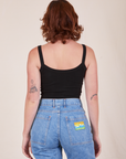 Back view of Cropped Cami in Basic Black and light wash Frontier Jeans worn by Alex
