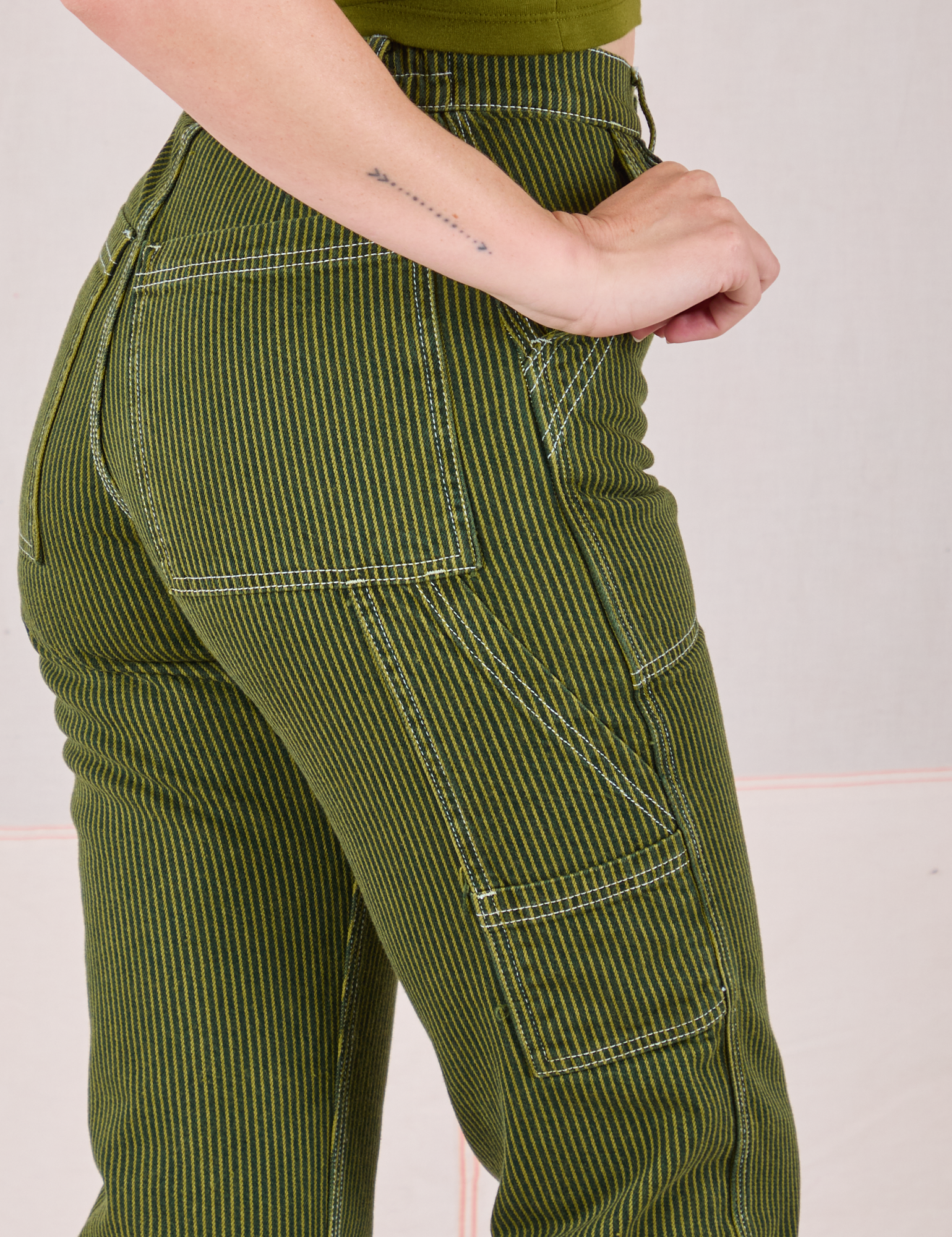 Railroad Carpenter Jeans in Summer Olive side close up on Alex