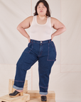 Ashley is 5'7" and wearing 1XL Carpenter Jeans in Dark Wash paired with Tank Top in vintage tee off-white