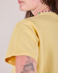 Cropped Burly Tee in Butter Yellow back shoulder and sleeve close up on Alex