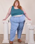 Catie is wearing Cropped Tank Top in Marine Blue paired with light wash Denim Trouser Jeans