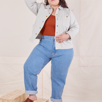 Ashley is 5'7" and wearing 1XL Denim Work Jacket in Dishwater White paired with light wash Frontier Jeans
