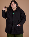 Sam is wearing a buttoned up Ripstop Field Coat in Basic Black