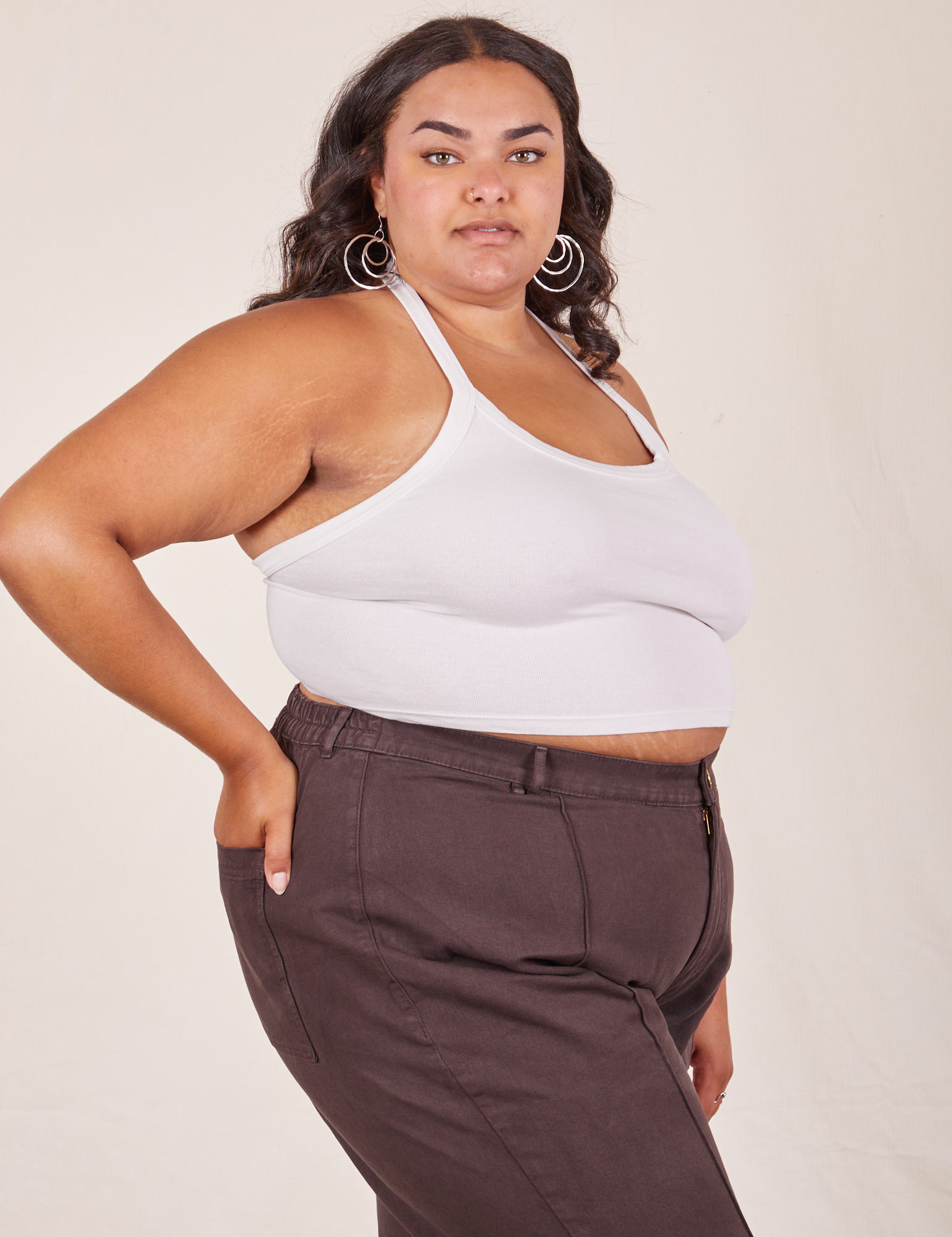 Angled side view of Halter Top in Vintage Off-White and espresso Western Pants worn by Alicia