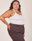 Angled side view of Halter Top in Vintage Tee Off-White and espresso Western Pants worn by Alicia